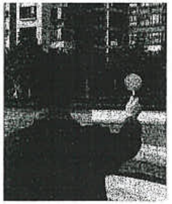 Photograph of a student viewing a distant object through a hand-held convex lens