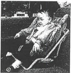 Photograph of a child sitting in a safety seat